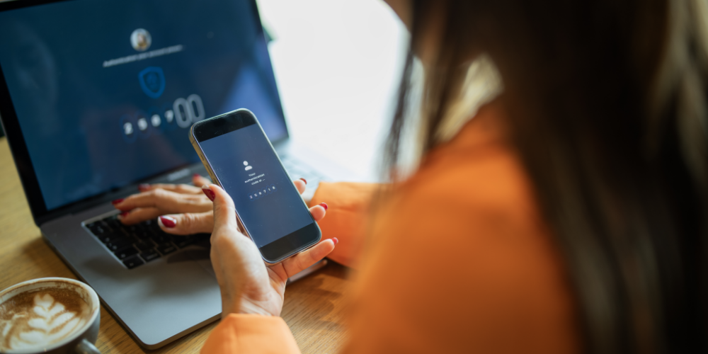 Woman on phone and computer typing password